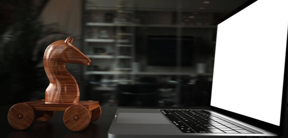 wooden horse next to laptop